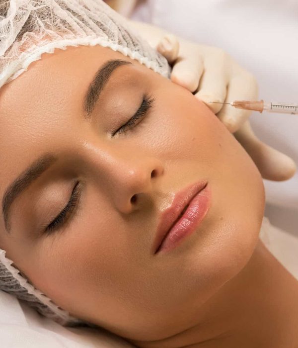 Woman in professional beauty salon during facial injections for rejuvenation